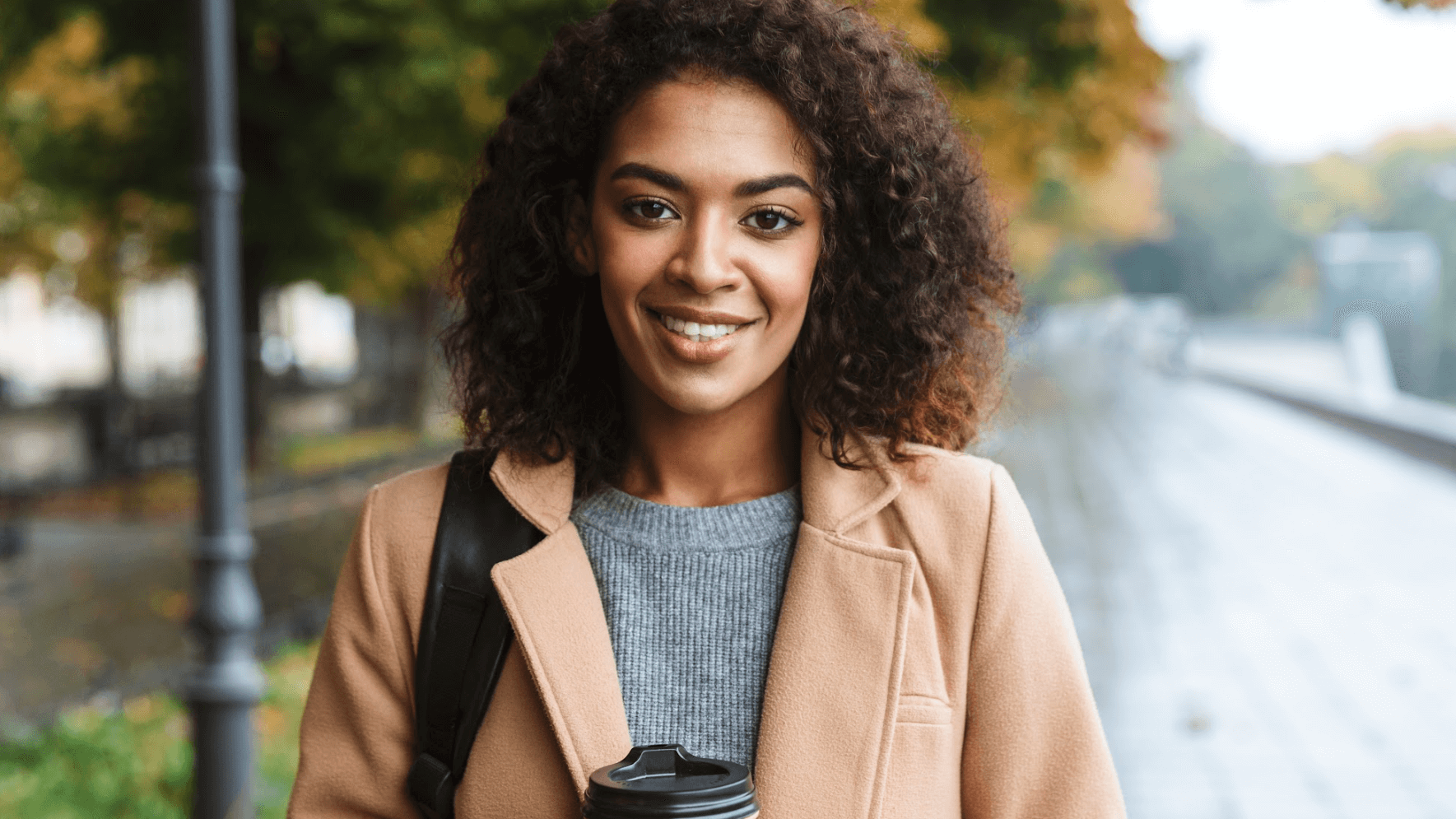 woman with coffee smiling outs
